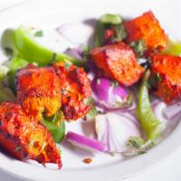 Chicken Tikka · Boneless succulent pieces of chicken marinated in herb and spices, cooked in tandoor.