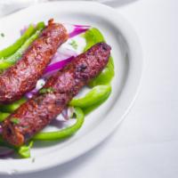 Seekh Kebab · Ground beef marinated with freshly ground spices and cooked in tandoor on a skewer.