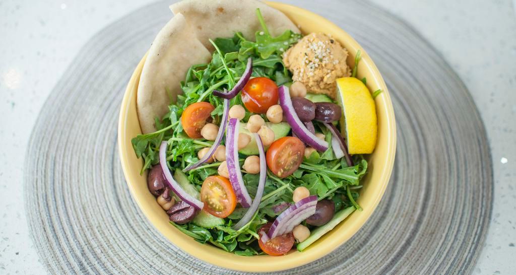Mighty Mediterranean · Garbanzo beans, cherry tomatoes, kalamata olives, cucumbers, red onions, arugula tossed with a kale hemp pesto & lemon vinaigrette over brown rice/quinoa mix. Served with Pita Bread and hummus.