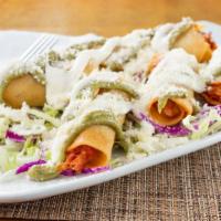 Taquitos (3) · Three taquitos filled with shredded brisket or shredded chicken, guacamole salsa, crema, cot...