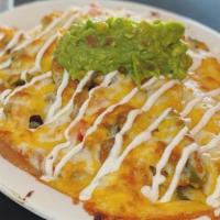 Nachos · Corn Tortilla Chips topped with Refried Beans, Onions, Tomatoes, Jalapeños, Monterey Jack an...