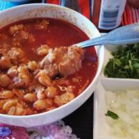 Pozole · Served with trimmings (repollo, rabanos, cebolla y limon) and tostadas.