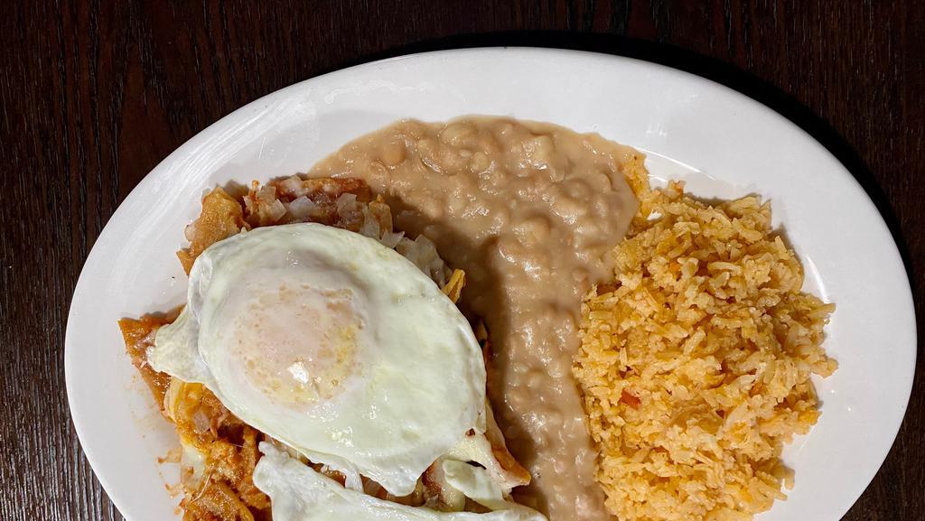 Chilaquiles · Corn tortilla chips, simmered in a red salsa, and topped with cheese and onions, and sour cream. Served alongside two eggs and beans.