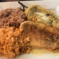 Chile Relleno Plate · Chile Relleno topped with sauce and served with rice, beans and a side of tortillas.