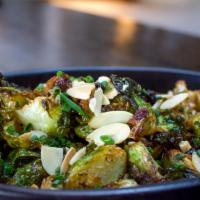 Brussels Sprouts · Toasted Almonds, currants, lemon-herb vinaigrette