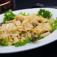 Kai Koow · Flat noodles with squid, chicken, egg and ground peanut on a bed of iceberg lettuce.