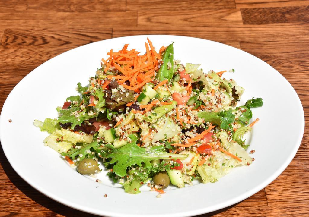 Organic Quinoa Salad · Gluten-free and vegetarian. Organic quinoa cooked in vegetable stock with a green mix, romaine lettuce, cucumber, tomato, olive, and carrots with a special balsamic dressing.