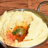 Hummus · Gluten-free and vegetarian. Pureed chickpeas topped with paprika and olive oil. Served with ...