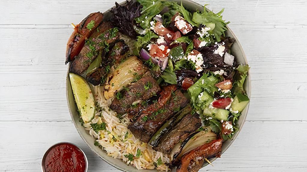 Beef Kabob Plate · Chargrilled cubes of beef served with basmati rice, side salad, fresh pita and your choice of sauce.