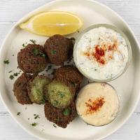 Falafel Plate · Fried falafel balls served with basmati rice, side salad, fresh pita and your choice of sauce.