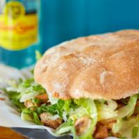 Torta · Mexican sandwich with chicken or steak, onion, lettuce, tomato & ancho-Chile mayo.
