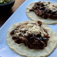 Mole Sauce Tacos (2) · Shredded chicken in mole sauce topped with cheese (queso fresco).