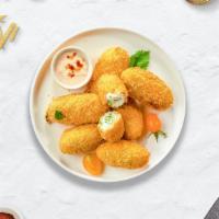 Jalapeno Poppers · (Vegetarian) Fresh jalapenos coated in cream cheese and fried until golden brown.