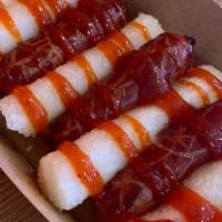 Sausage And Rice Cake (So Dduk So Dduk) · Sausage and rice cake on skewer with sweet and spicy sauce on top