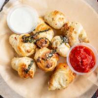 Garlic Notes (8) · Baked pizza dough tossed in garlic herb butter, served with ranch or marinara.