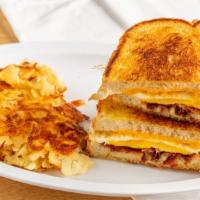 Farmers Favorite Sandwich · Two fried eggs, cheese, and your choice of bacon, ham or sausage, on grilled sourdough. Serv...