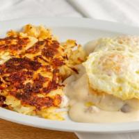 Biscuits & Gravy · An open faced biscuit, covered in delicious gravy and sausage, served with eggs and hash bro...