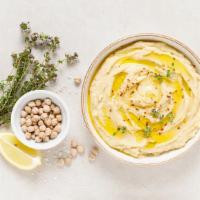 Lemon Garlic Hummus · Chickpeas blended with tahini, olive oil, lemon and spices (served with warm pita bread).