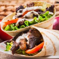 Fg'S Beef Shawarma Wrap · A wrap filled with thinly sliced rotisserie style chicken, lettuce, tomato, cucumber and oni...