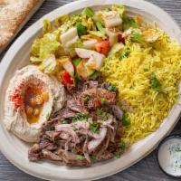 Beef Shawarma Combo Platter · Beef Shawarma with sautéed onion and tomatoes over Greek rice, French fries and topped with ...