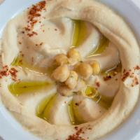 Hummus · Garbanzo beans, Tahini, and a touch of lemon served with either warm or toasted pita bread.