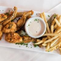 Frog Legs · Pan-fried with lemon topped with cilantro and French fries.
