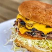 Double Cheeseburger · 2 burger patties in a toasted burger bun dressed with 1000 island, onions, tomato, and 2 ame...