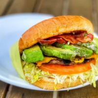 Bacon Avocado Cheeseburger · Burger patty in a toasted burger bun dressed with 1000 island, onions, tomato, bacon, avocad...