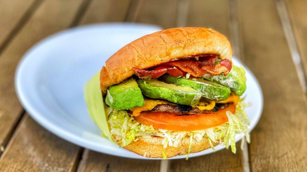 Bacon Avocado Cheeseburger · Burger patty in a toasted burger bun dressed with 1000 island, onions, tomato, bacon, avocado and american cheese
