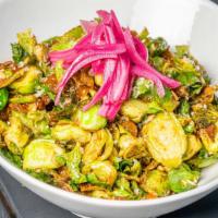 Brussel Sprouts · fried brussels, golden raisin, sunflower seeds, fresh herbs, pickled cabbage & cilantro, ser...