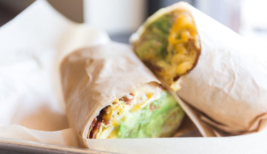 Breakfast Burrito · Choice of applewood bacon or home-made sausage, eggs, crispy tater tots, American cheese, avocado, chomp salsa, tomatoes, red onions on a gourmet white tortilla.