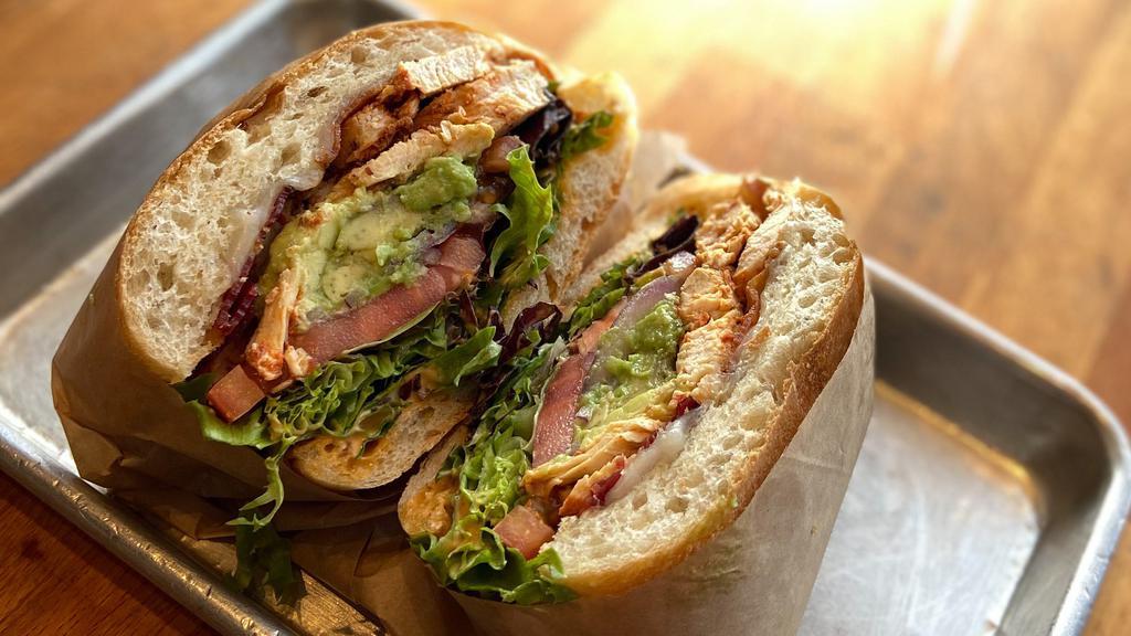 Chipotle Chicken Avocado Sandwich · 100% All-Natural chicken, applewood bacon, fresh avocado, chipotle aioli, provolone cheese, mixed greens, tomatoes, red onions on a ciabatta.