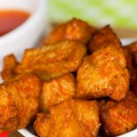 Buffalo Fried Chicken · Crispy battered deep-fried chicken tossed with classic buffalo sauce.