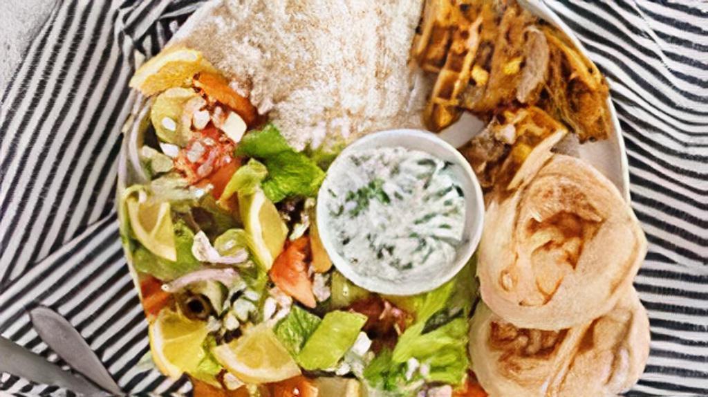 Chicken Shawarma Plate · Tender strips of grilled chicken served with basmati rice, side salad, fresh pita, and a side of tahini