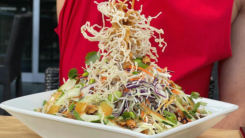 Thai Crunch Salad · Micky's favorite. Red & white cabbage, carrots, scallions, cucumber, edamame, roasted peanuts, cilantro, avocado, creamy peanut dressing, crunchy rice sticks, grilled organic chicken.
