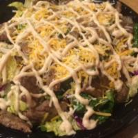 16: Gyro Salad · Grilled beef & lamb, served with our special garlic dressing.