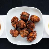 Vegetable Pakoras · Crisp fritters of spinach, cauliflower and onion in chickpea flour served with tamarind and ...