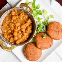 Aloo Tikki · Potato cutlets served with channa masala, chutney and tamarind sauce.