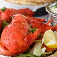 #297 Tandoori Chicken Breast & Leg · Tender chicken marinated in yogurt and spices, broiled over mesquite in the tandoor.