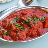 Chicken Vindaloo · Boneless chicken and potatoes cooked in hot cherry sauce with herbs and spices.