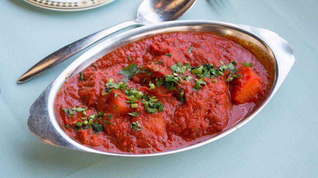 Chicken Vindaloo · Pieces of chicken in hot spices, in a highly seasoned gravy of potatoes, tomatoes and chili pepper.
