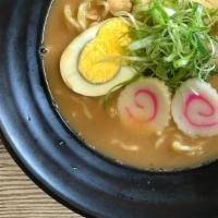 Tonkotsu Ramen · Ramen noodle with special pork based broth comes with egg, fishcake two pieces of pork and m...