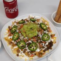 Nachos · Choose of meat (steak, chicken, carnitas, al pastor, or veggies) fried tortillas, beans, che...