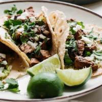 Street Tortilla Tacos · choose of meat (steak, chicken, carnitas, al pastor, or veggies) salsa, limes, with cilantro...