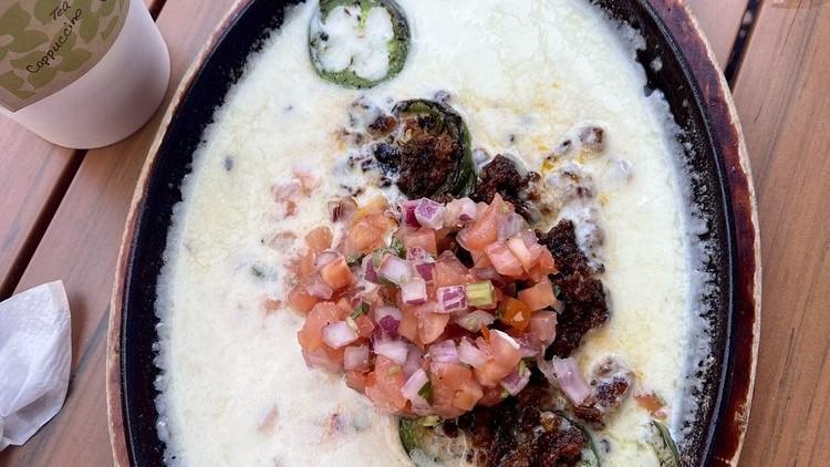 Queso Fundido · Monterey & Pepperjack Cheese + Pico + Topping Choice of Grilled Jalapeños or Pork Chorizo.