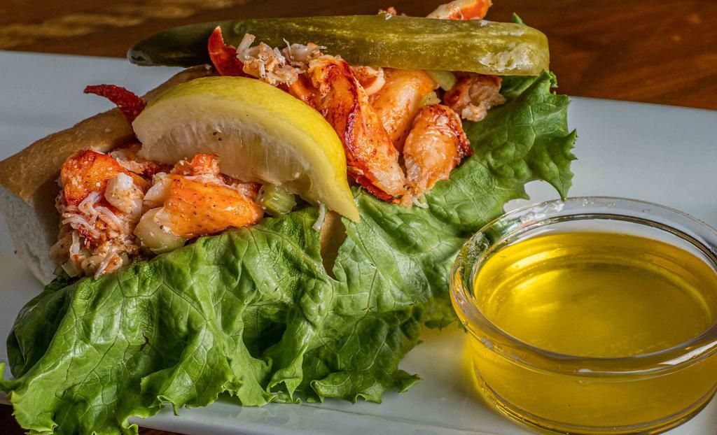Lobster Roll · A 1/4 pound of Maine lobster meat seasoned with fresh lemon, celery and old bay on a split top roll with lemon aioli, leaf lettuce, pickle spear and lemon wedge. Served with malt vinegar potato chips.