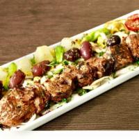 Filet Mignon · Skewered marinated chunks of filet mignon with rice, salad, bread, onion & herbs.