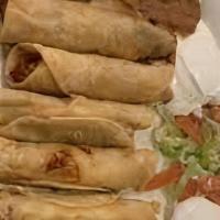 Crispy Flautas (Five) · Salsa, chicken, and cheese rolled into flour tortillas and lightly fried. Topped with cheese...