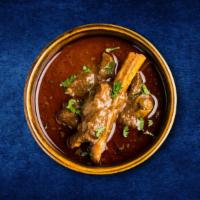 Just Goat Curry · Soft tender pieces of goat meat cooked in onion, tomato gravy and with spices served with sm...