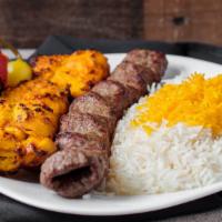 The Combo (1 Beef 1 Chicken) · Skewers of char-broiled chicken breast tender and a ground beef kabob sitting on top of whit...